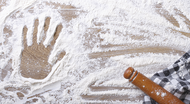 Handprint on the flour and rolling pin, a kitchen towel